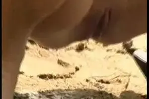 Chick piss on sandy beach