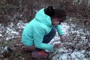 Alina pooping in the winter forest