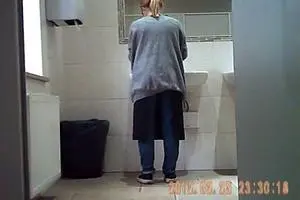 Pissing girl. Hidden camera in the toilet