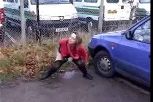 Woman pissing in the parking lot