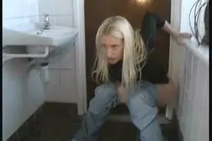 The girl pisses on the floor in the toilet